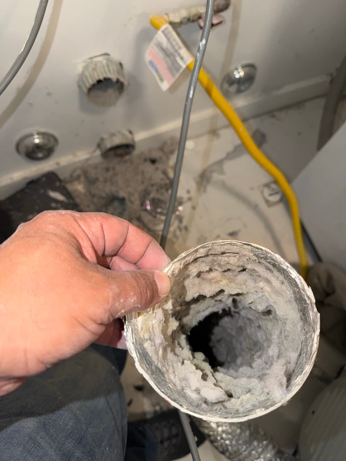 A dryer transition duct pulled out and completely clogged with packed lint