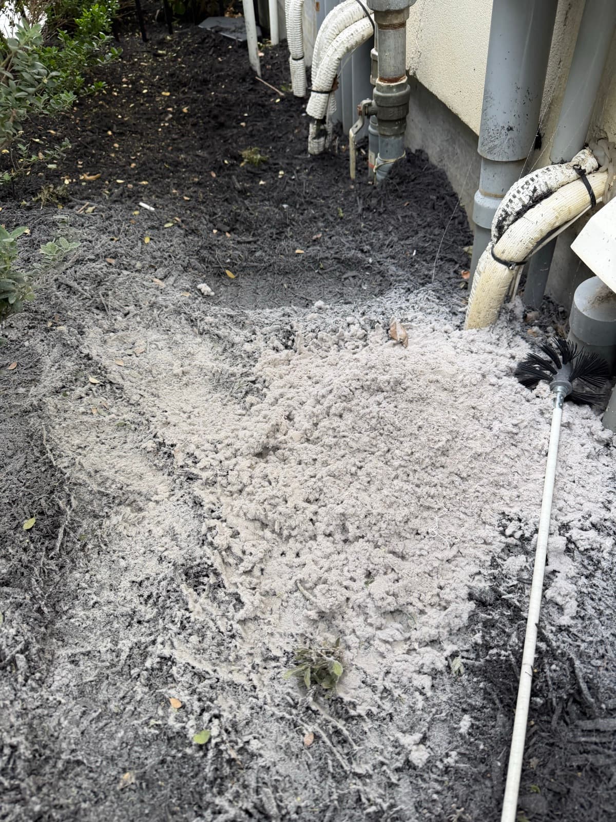 A large pile of lint removed from a single home's dryer vent line with the cleaning brush